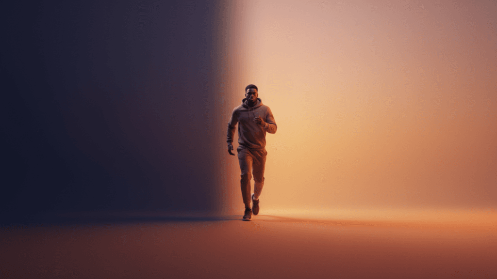 Man stepping forward into light from a dark shadow, symbolizing courage and motivated with soft gradient background